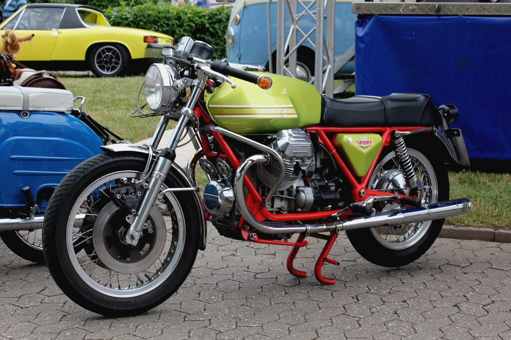 A 1973 Moto Guzzi V7 Sport. Low, long, with the cylinders sticking out left and right like arms.